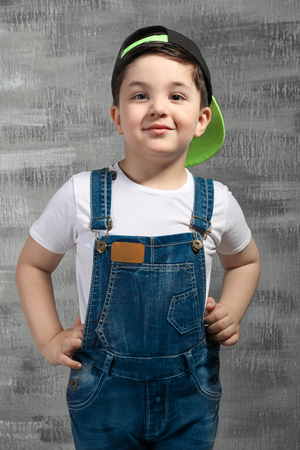 Cute little boy near grey wallの写真素材