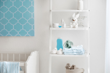 Beautiful light room with toys and baby accessories on shelvesの写真素材