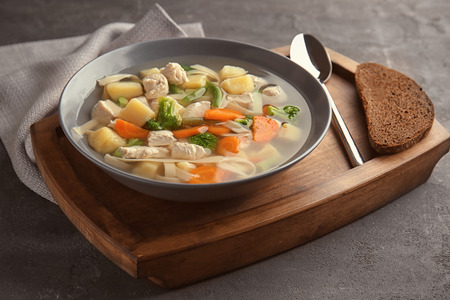 Plate with delicious turkey soup on tableの写真素材