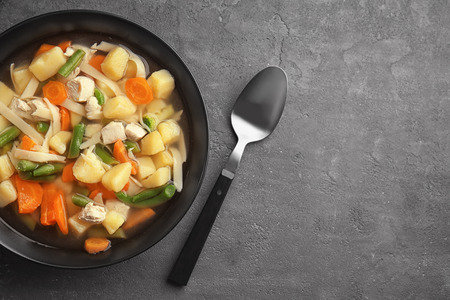 Plate with delicious turkey soup on tableの写真素材