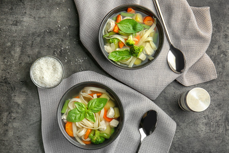 Two bowls with delicious turkey soup on tableの写真素材