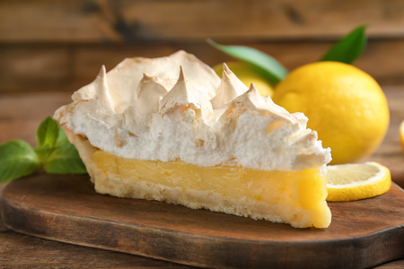 Piece of yummy lemon meringue pie on wooden tableの写真素材