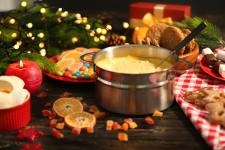 Beautiful composition with cheese fondue on tableの写真素材