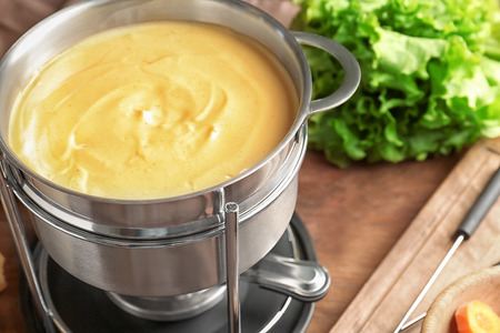 Cheese fondue on wooden backgroundの写真素材