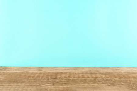 Wooden table against mint backgroundの写真素材