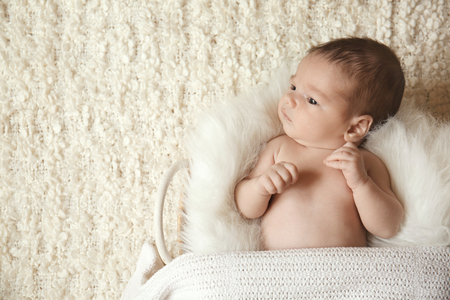Newborn baby boy lying in basket at homeの写真素材