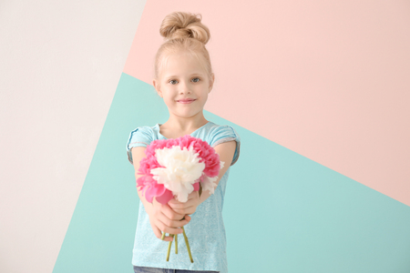 Cute funny girl with bouquet of flowers on color backgroundの写真素材