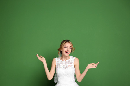 Young beautiful bride on color backgroundの写真素材