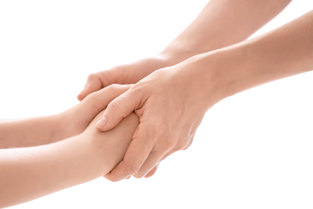 Mother and daughter holding hands together on white background, closeupの写真素材