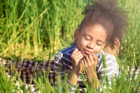 Little Afro American girl in green fieldの写真素材