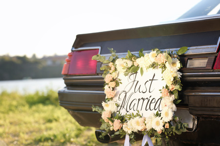 Beautiful wedding car with plate JUST MARRIED outdoorsの写真素材