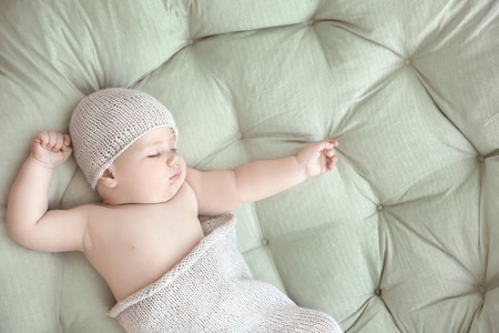 Cute little baby sleeping on lounge at homeの写真素材