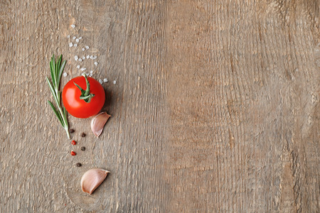 Composition with fresh rosemary and vegetables on wooden backgroundの写真素材