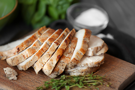 Delicious sliced turkey breast on wooden boardの写真素材