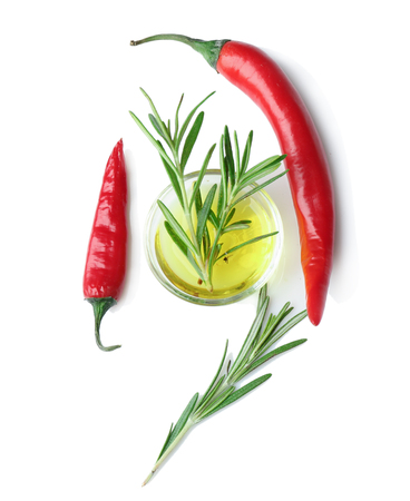 Composition with fresh rosemary and chili on white backgroundの写真素材