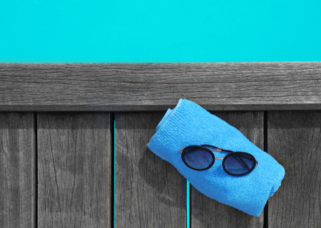 Towel and sunglasses on wooden pontoon at sea resort. Summer vacation conceptの写真素材
