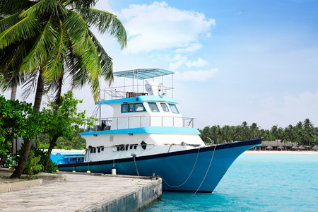 Modern boat berthed at tropical resortの写真素材