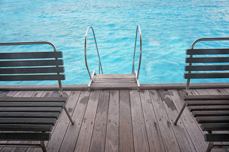 Pontoon with wooden benches and stair at sea resort in summer dayの写真素材