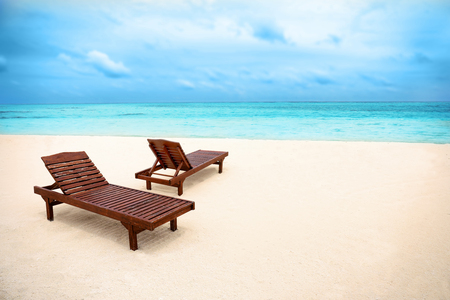 Sun loungers on beach in summer dayの写真素材
