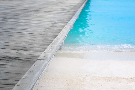 Wooden pontoon on beach in summer day