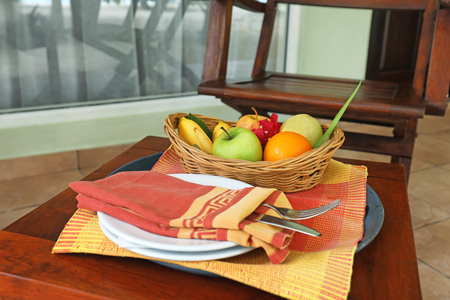 Fresh tasty fruits for breakfast on small wooden tableの写真素材