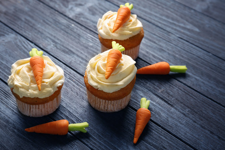 Delicious carrot cupcakes on wooden backgroundの写真素材
