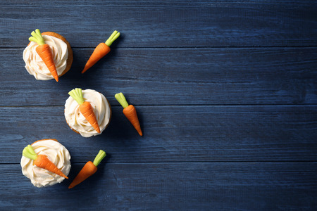 Delicious carrot cupcakes on wooden backgroundの写真素材