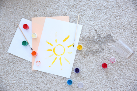 Picture, paints and spilled water on carpetの写真素材