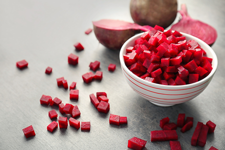 Bowl with sliced beetroot on table