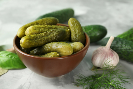 Bowl with pickled cucumbers on tableの写真素材
