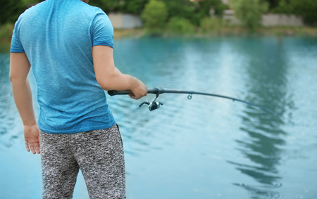 Man fishing on riverの写真素材