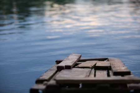Old wooden pier on riverの写真素材