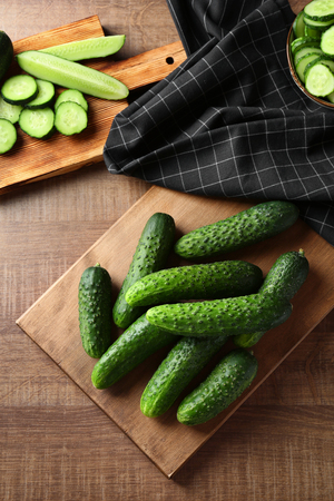 Green fresh cucumbers on wooden boardの写真素材