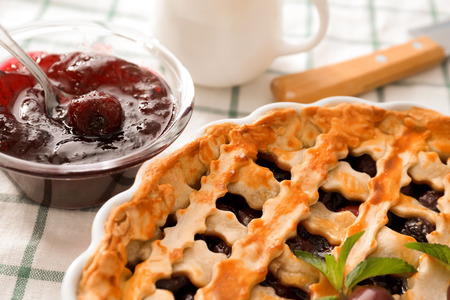 Delicious cherry pie on kitchen tableの写真素材