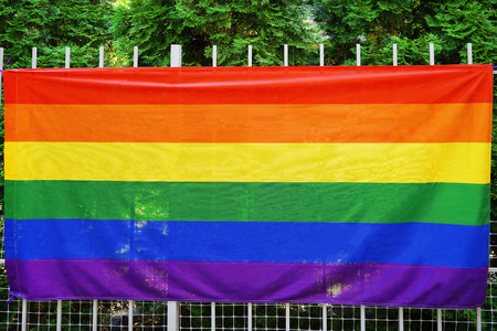 Gay flag on fence outdoorsの写真素材