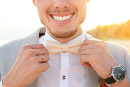 Handsome groom in wedding suit on beach, closeupの写真素材