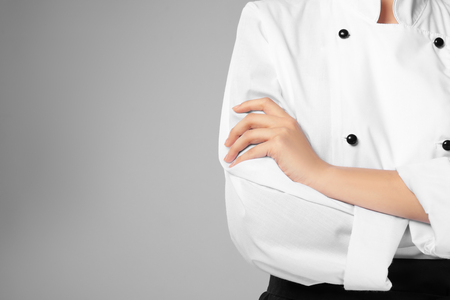 Young female chef on light background, closeupの写真素材