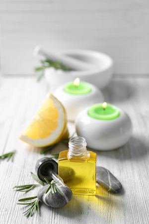 Bottle with rosemary oil on wooden tableの写真素材