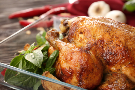 Baking dish with roasted turkey on tableの写真素材