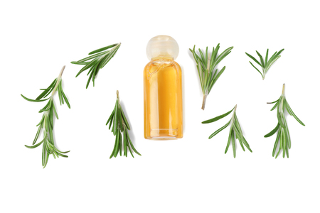 Bottle with rosemary oil and herb on white backgroundの写真素材