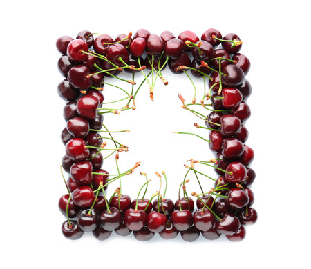 Frame made of fresh cherries on white backgroundの写真素材