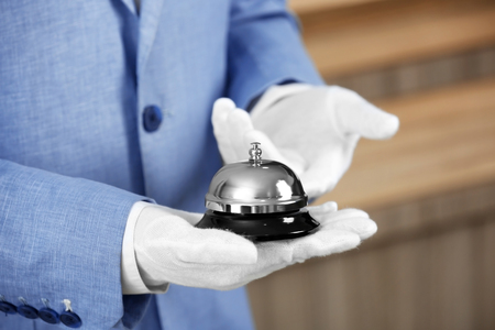 Man holding bell on blurred background