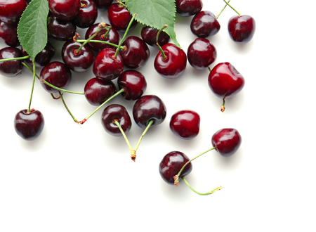 Heap of ripe cherries on white background
