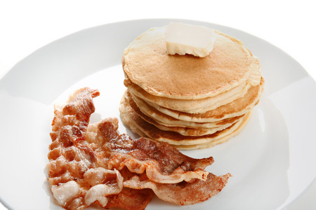 Pancakes with butter and bacon on white backgroundの写真素材