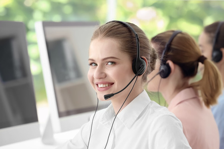 Young female technical support dispatcher working in office