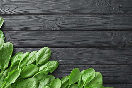 Fresh spinach leaves on wooden backgroundの写真素材
