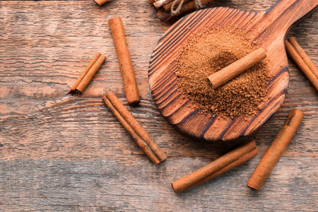 Composition with cinnamon sugar and stick  on wooden backgroundの写真素材
