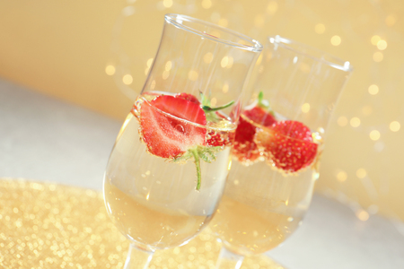 Glasses of delicious wine with strawberry on blurred backgroundの写真素材