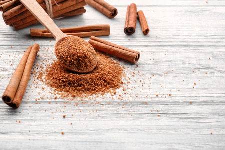 Cinnamon sugar in spoon on wooden backgroundの写真素材