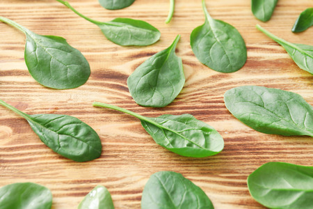 Fresh spinach leaves on wooden backgroundの写真素材